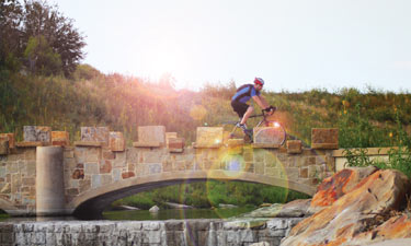 A cyclist in San Antonio takes advantage of a brand-new connecting trail across the San Antonio River. The Mission Reach project of the San Antonio River Authority includes 15 miles of new trails along the river.