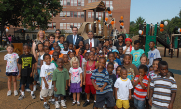 Mayor Gray (in blue tie) and D.C. Parks Director Jesús Aguirre (in red tie) announce a playground renovation program.