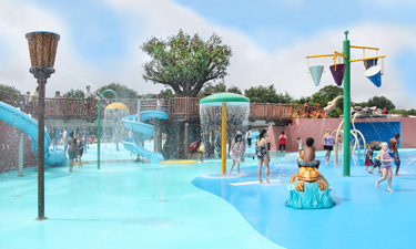 Community members and leaders cut the ribbon for Wyandanch's $10 million water playground. Photo by Ola Wilk.