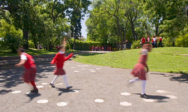 In this outdoor area at a Bronx school, architect Katie Winter included surface patterns, poles, rocks and hills to encourage kids to jump, swing and climb.