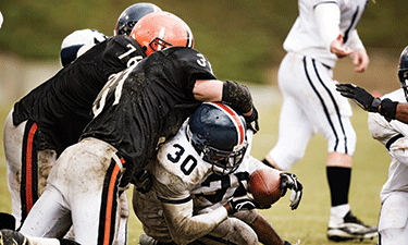 When is it appropriate for a high school football player to wear a helmet and mouthguard to practice, and who is responsible for making sure the athlete is in compliance with those rules?