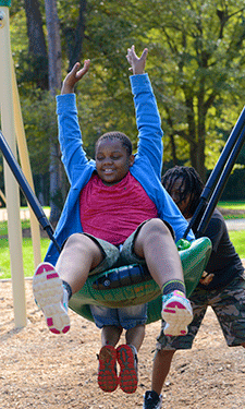 Neighborhood kids from the Lincoln Heights community jumped at the chance to finally use the playground they had watched being constructed for weeks.