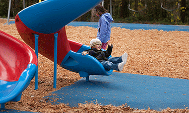 Impact-attenuating surfaces, like this one installed by TotTurf at a Portland, Oregon, park, can include multiple types of materials.